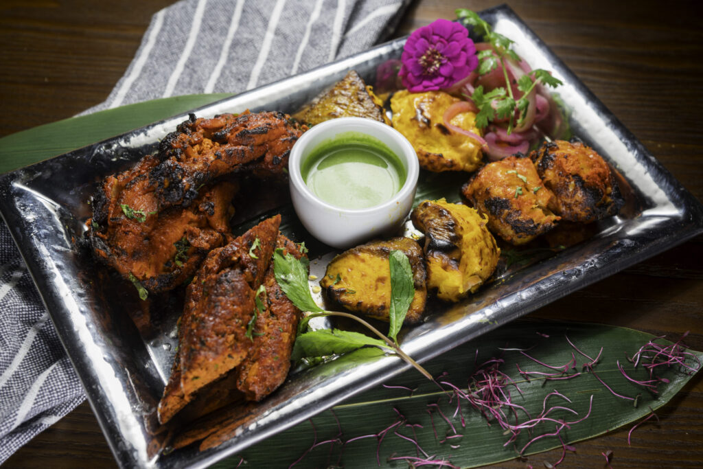 Indian non-vegetarian tandoori platter with assorted grilled meats and spices.