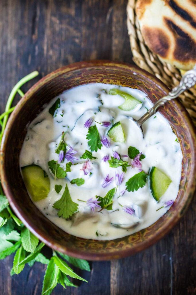 Mixed raita with yogurt, cucumber, onions, and roasted cumin.